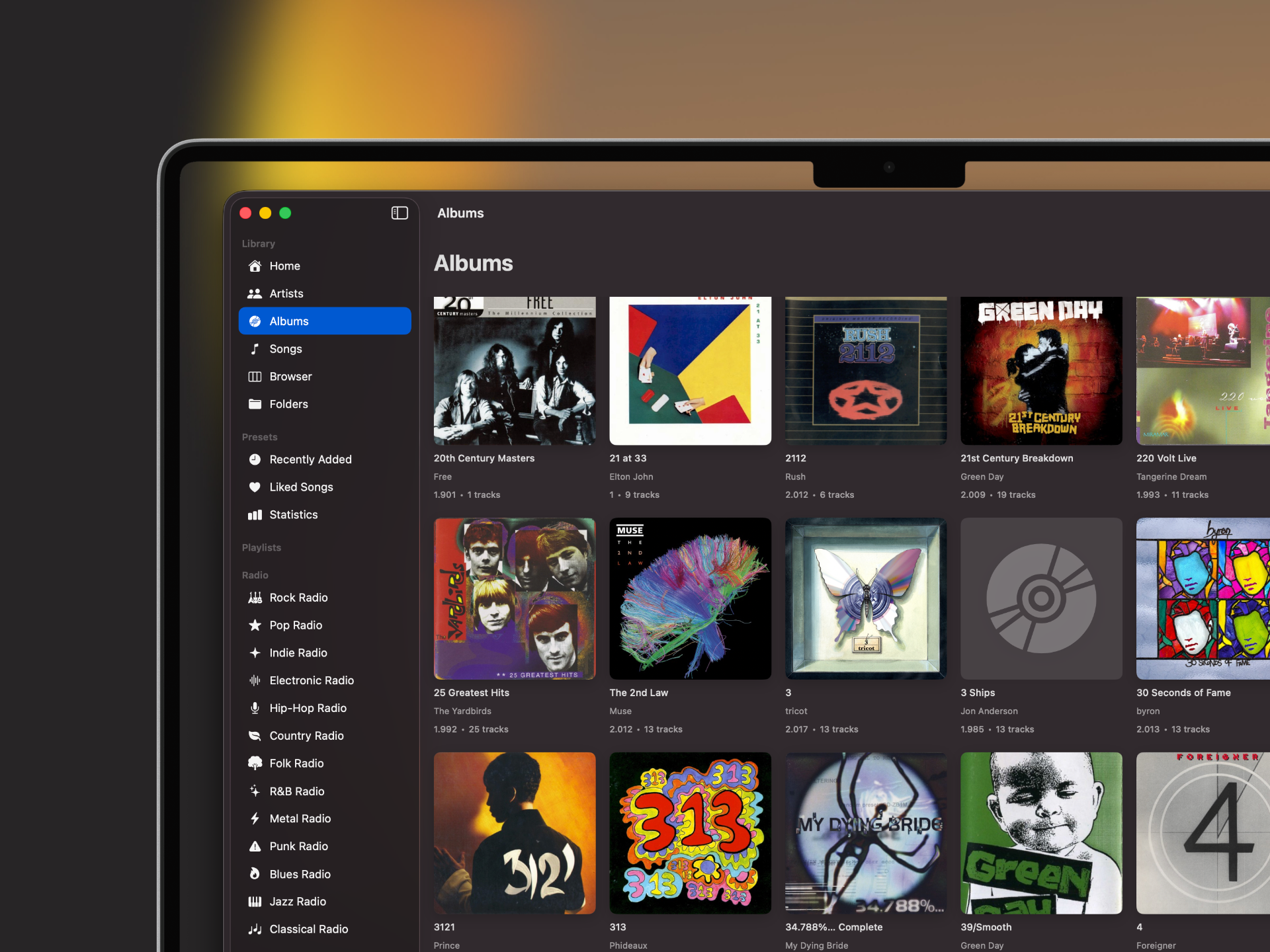 Album grid library view with sidebar navigation and playlists